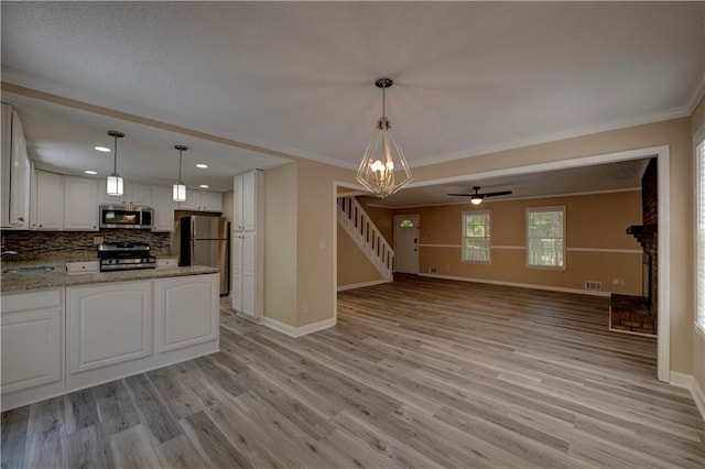 535 Toonigh Rd, Woodstock, GA 30188 - unfurnished living room featuring stairway, light wood finished floors, baseboards, crown molding, and recessed lighting