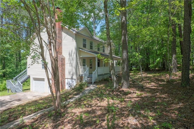 535 Toonigh Rd, Woodstock, GA 30188 - view of front of house featuring stairway, covered porch, concrete driveway, a garage, and a chimney