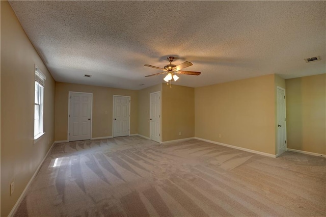535 Toonigh Rd, Woodstock, GA 30188 - unfurnished room with light carpet, a ceiling fan, a textured ceiling, and baseboards