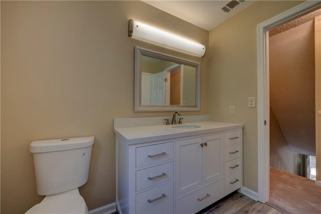 535 Toonigh Rd, Woodstock, GA 30188 - half bathroom with toilet, vanity, wood finished floors, and baseboards