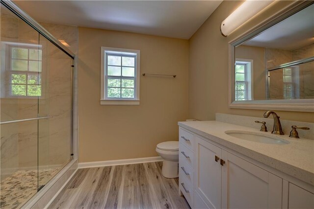 535 Toonigh Rd, Woodstock, GA 30188 - full bathroom featuring toilet, a stall shower, wood finished floors, baseboards, and vanity