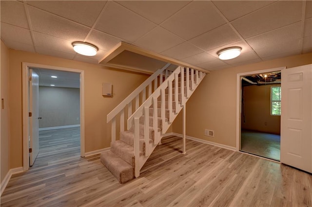 535 Toonigh Rd, Woodstock, GA 30188 - stairway featuring a paneled ceiling, wood finished floors, and baseboards