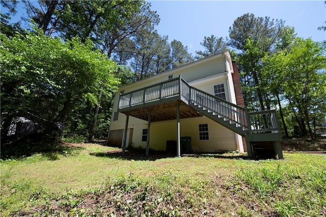 535 Toonigh Rd, Woodstock, GA 30188 - rear view of house featuring a deck, stairs, and a lawn