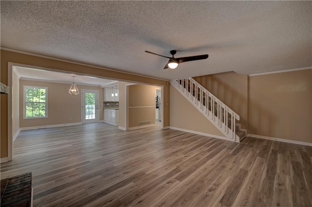 535 Toonigh Rd, Woodstock, GA 30188 - unfurnished living room featuring stairs, wood finished floors, a textured ceiling, a ceiling fan, and baseboards