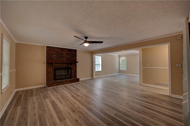 535 Toonigh Rd, Woodstock, GA 30188 - unfurnished living room with ornamental molding, a textured ceiling, wood finished floors, a ceiling fan, and a fireplace