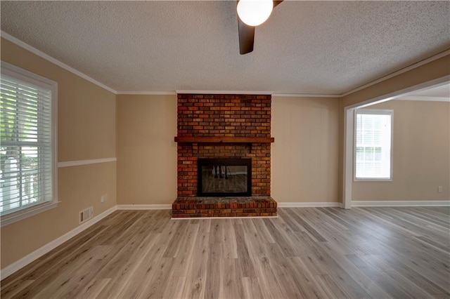 535 Toonigh Rd, Woodstock, GA 30188 - unfurnished living room featuring light wood-style floors, a textured ceiling, a ceiling fan, a fireplace, and baseboards