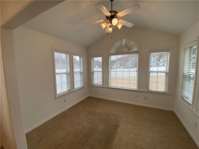 tiled spare room with lofted ceiling, baseboards, and ceiling fan