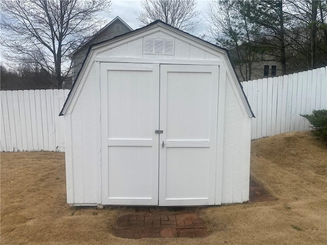 view of shed featuring fence