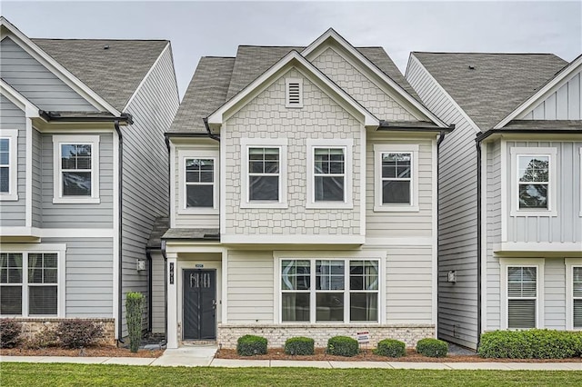 view of front of house with board and batten siding and brick siding