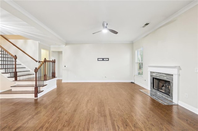 2760 Lions Gate Dr, Cumming, GA 30041 - unfurnished living room featuring a ceiling fan, wood finished floors, stairs, ornamental molding, and a premium fireplace