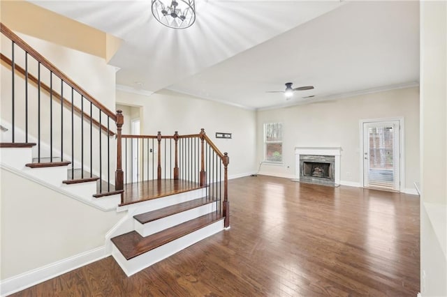 2760 Lions Gate Dr, Cumming, GA 30041 - stairs with a ceiling fan, wood finished floors, ornamental molding, baseboards, and a high end fireplace