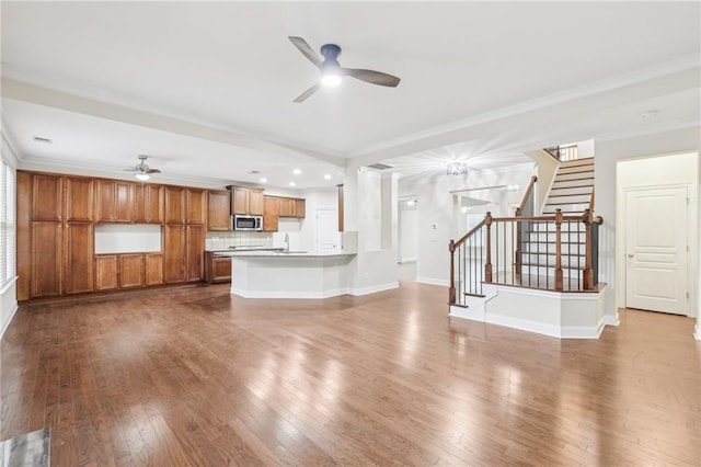 2760 Lions Gate Dr, Cumming, GA 30041 - unfurnished living room featuring a ceiling fan, dark wood-style flooring, stairs, crown molding, and recessed lighting
