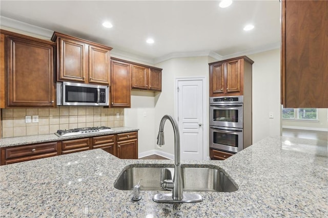 2760 Lions Gate Dr, Cumming, GA 30041 - kitchen with stainless steel appliances, a sink, light stone countertops, decorative backsplash, and recessed lighting
