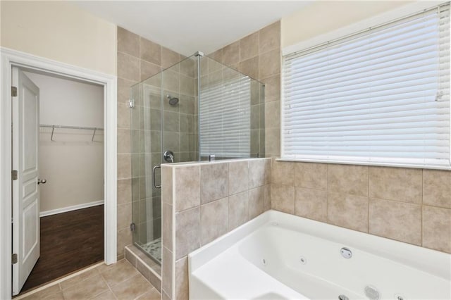 2760 Lions Gate Dr, Cumming, GA 30041 - full bathroom featuring a stall shower, a tub with jets, a walk in closet, and tile patterned flooring