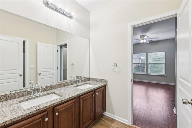 2760 Lions Gate Dr, Cumming, GA 30041 - full bath featuring baseboards, ceiling fan, wood finished floors, and double vanity