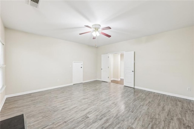 2760 Lions Gate Dr, Cumming, GA 30041 - spare room with a ceiling fan, wood finished floors, and baseboards