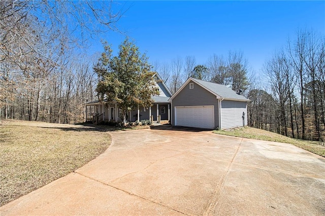 view of front facade with an attached garage, concrete driveway, and a front lawn