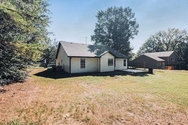 back of house featuring a patio area and a yard