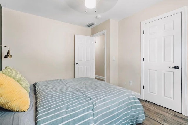 bedroom featuring visible vents, wood finished floors, and a ceiling fan