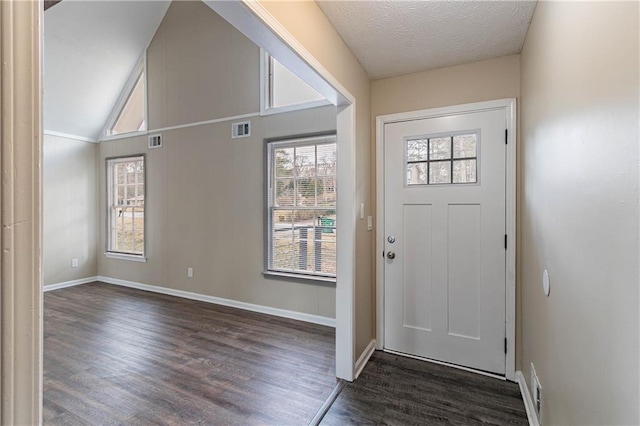 foyer entrance with lofted ceiling, baseboards, visible vents, and dark wood-type flooring