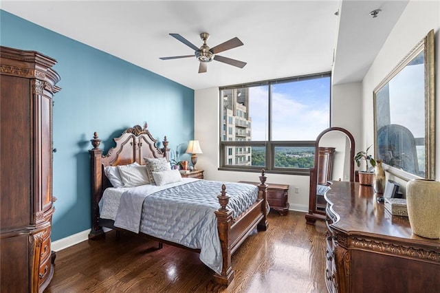 bedroom with dark hardwood / wood-style floors and ceiling fan