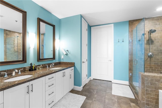 bathroom featuring an enclosed shower and vanity