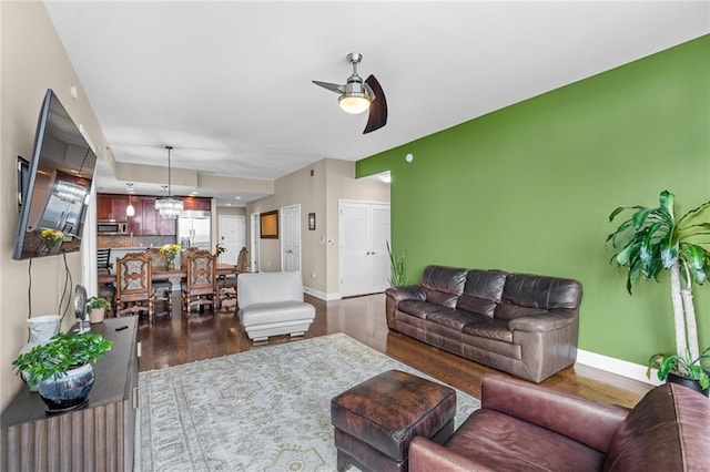 living room with ceiling fan and hardwood / wood-style floors