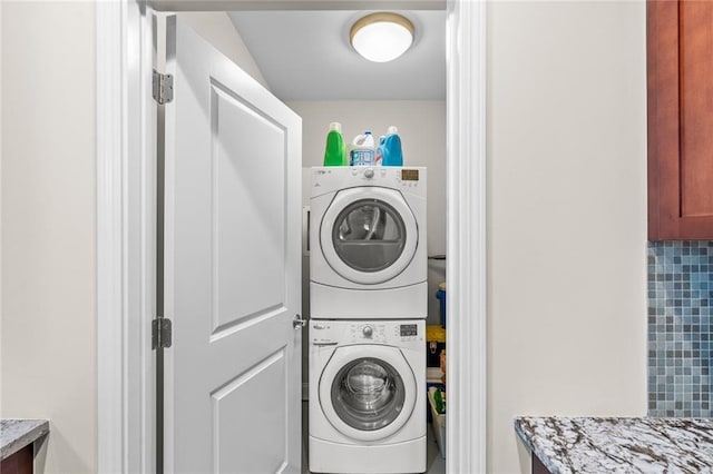 washroom featuring stacked washer and dryer