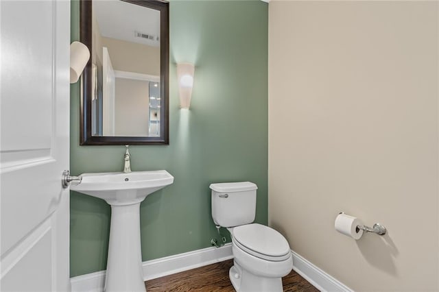 bathroom with sink, wood-type flooring, and toilet