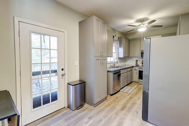 kitchen with gray cabinetry, stainless steel appliances, light hardwood / wood-style floors, a healthy amount of sunlight, and ceiling fan