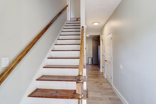 stairs with hardwood / wood-style flooring