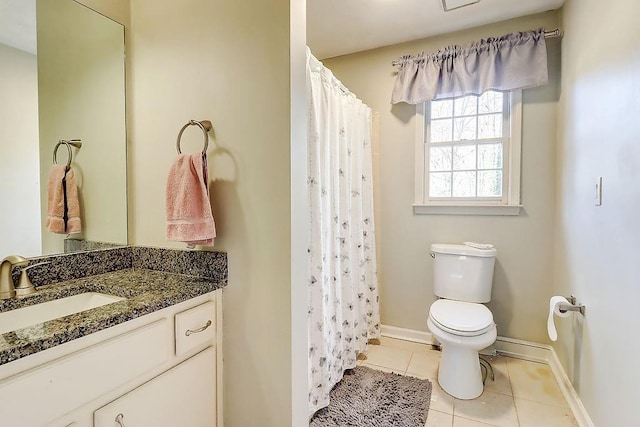 bathroom featuring curtained shower, tile patterned flooring, vanity, and toilet