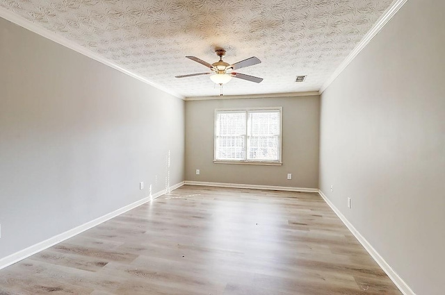 empty room with a textured ceiling, ceiling fan, ornamental molding, and light hardwood / wood-style flooring