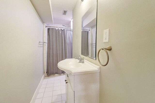 bathroom featuring a shower with shower curtain, vanity, and tile patterned floors