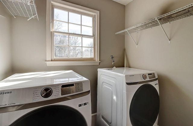 clothes washing area with separate washer and dryer