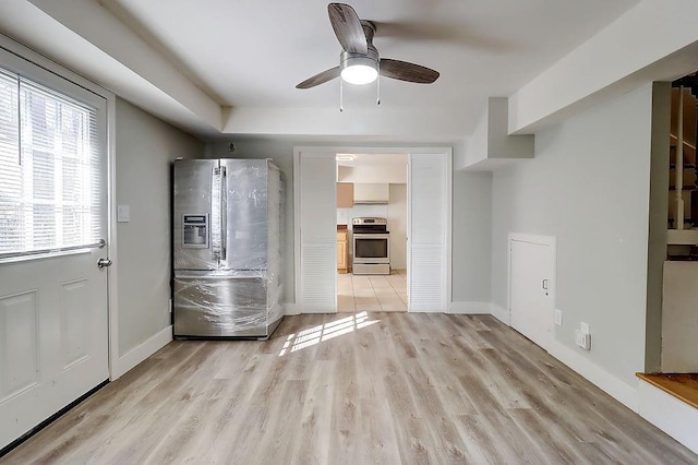 interior space featuring ceiling fan, a wealth of natural light, and light wood-type flooring