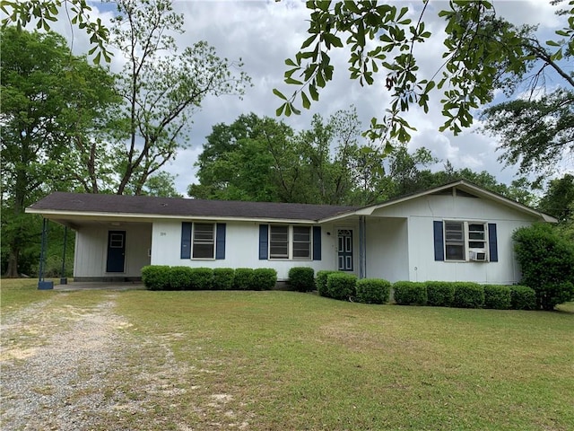 single story home featuring dirt driveway, a carport, a front lawn, and cooling unit