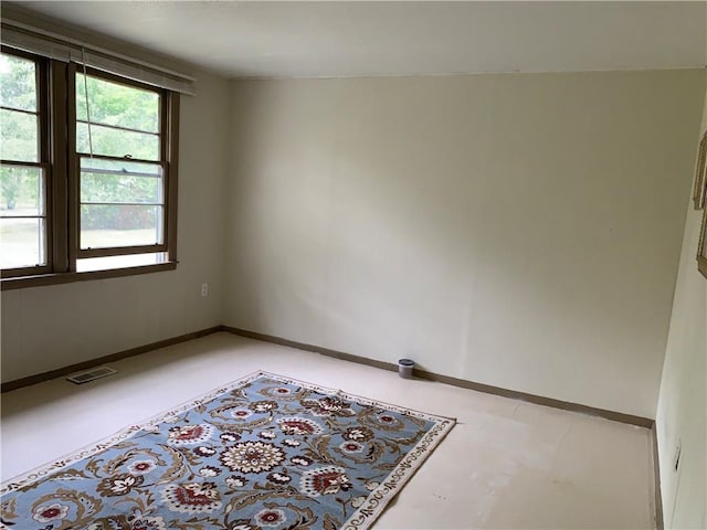 spare room with baseboards and visible vents