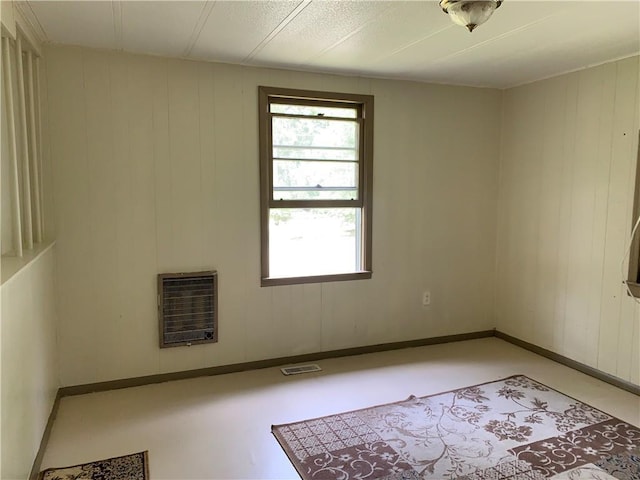 empty room with visible vents and heating unit