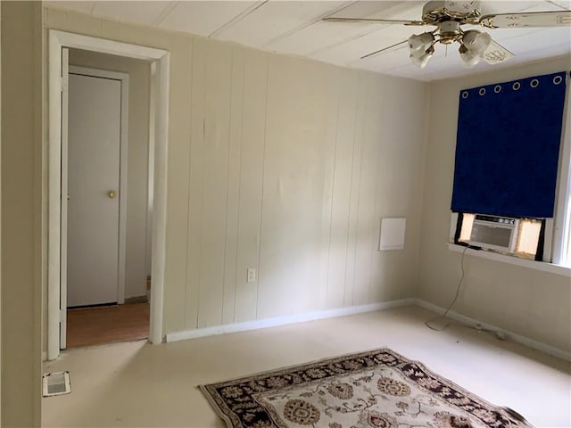 spare room with a ceiling fan and cooling unit