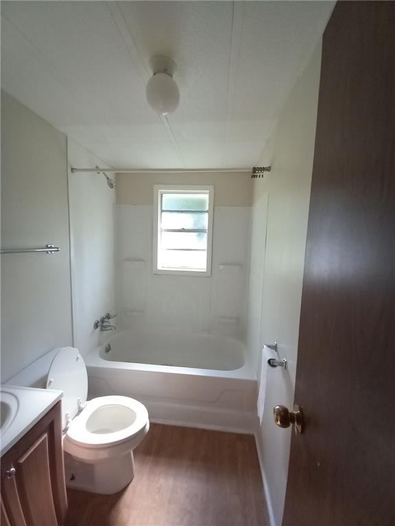 full bathroom featuring vanity, washtub / shower combination, wood finished floors, and toilet