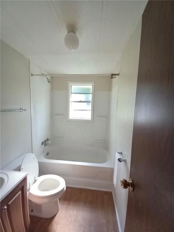 bathroom featuring vanity, toilet, shower / tub combination, and wood finished floors