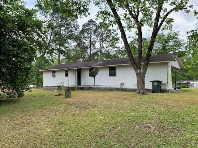 back of property featuring a yard and crawl space