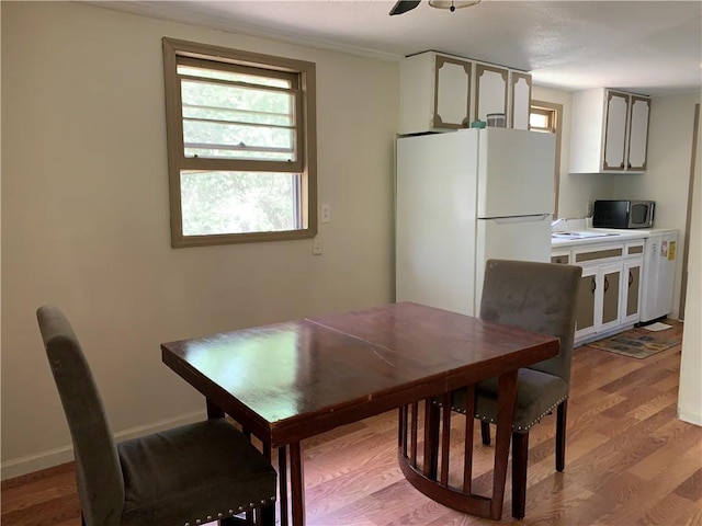 dining space with wood finished floors