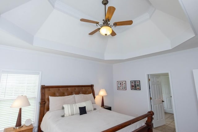 bedroom featuring ornamental molding, ceiling fan, and a tray ceiling