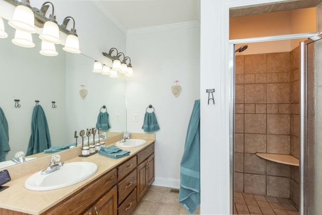 bathroom featuring crown molding, a tile shower, tile patterned floors, and vanity