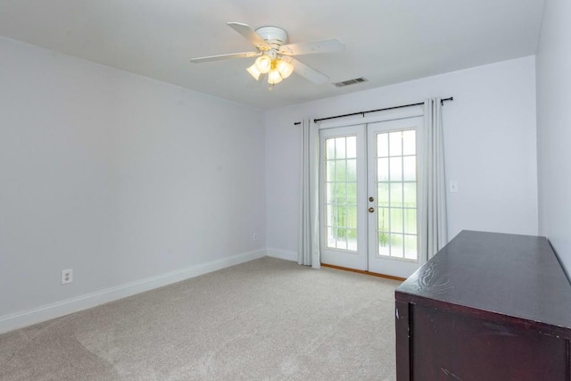 doorway with light colored carpet, french doors, and ceiling fan