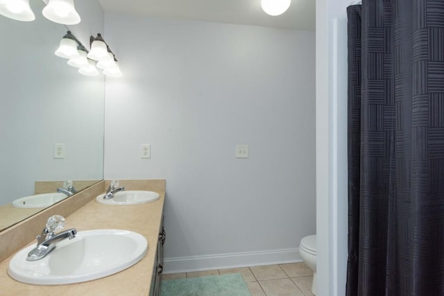 bathroom featuring vanity, tile patterned floors, and toilet