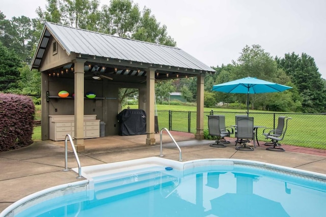 view of pool featuring a patio, grilling area, and a lawn