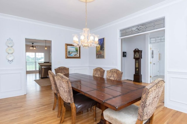 dining room with ornamental molding, a chandelier, and light wood-type flooring